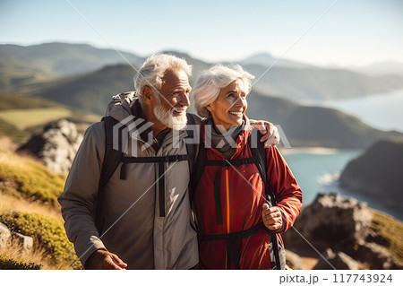 Awe-Inspiring Retirement Senior Couple Marvels at Pacific Coast Beauty, Embracing Nature's Wonders on a Mountain Hiking Adventure. created with Generative AI 117743924
