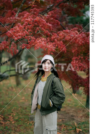 Portrait of a young Asian woman with autumn leaves 117745393
