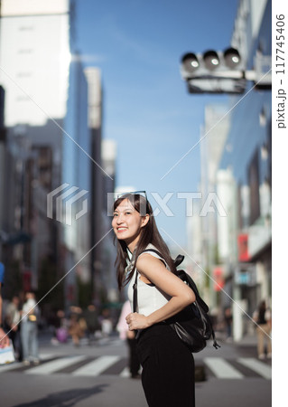 Urban chic, Trendy young lady in Tokyo, radiating positivity and success, showcasing dynamic lifestyle of modern Japanese women. Urban chic, Trendy young lady in Tokyo, radiating positivity and success, showcasing dynamic lifestyle of modern Japanese women. 117745406