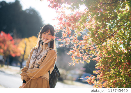 Casual dress elegance, Asian woman explores Kyoto's fall beauty, capturing cheerful smiles amid vibrant foliage and the scenic allure of Japanese tradition during a holiday. Casual dress elegance, Asian woman explores Kyoto's fall beauty, capturing cheerful smiles amid vibrant foliage and the scenic allure of Japanese tradition during a holiday. 117745440