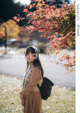 Casual dress elegance, Asian woman explores Kyoto's fall beauty, capturing cheerful smiles amid vibrant foliage and the scenic allure of Japanese tradition during a holiday. Casual dress elegance, Asian woman explores Kyoto's fall beauty, capturing cheerful smiles amid vibrant foliage and the scenic allure of Japanese tradition during a holiday. 117745441