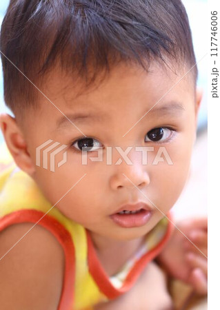 Asian boy about two years old in a yellow shirt was sitting. Asian boy about two years old in a yellow shirt was sitting. 117746006