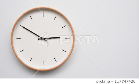 Minimalist wooden Wall Clock on White Wooden Surface with Space for Text. Time Set at 14.50, 02.50 117747420