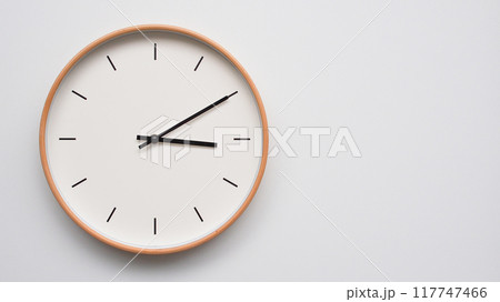Minimalist wooden Wall Clock on White Wooden Surface with Space for Text. Time Set at 15.10/03.10 117747466