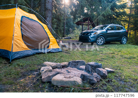Camping Scene with SUV and Yellow Tent 117747596