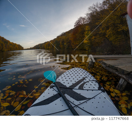 Paddleboarding on a Serene Autumn Lake 117747668