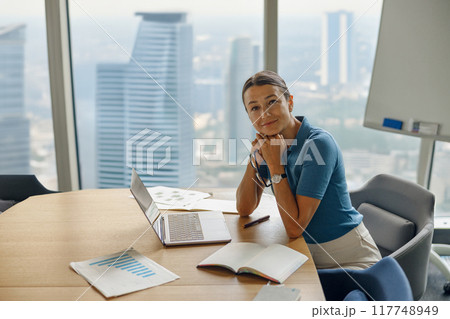 A Professional Businesswoman in a Modern Office Setting Exuding Confidence and Authority 117748949