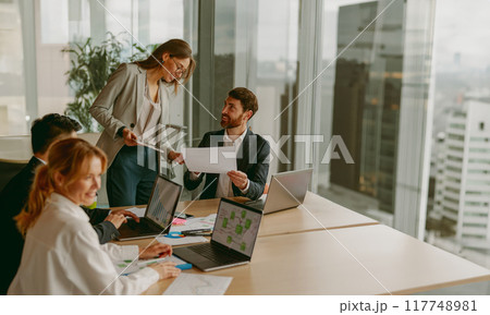 A Business Meeting Takes Place in a Modern Office Environment Promoting Team Collaboration 117748981