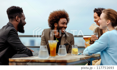Friends Enjoying Drinks Together at Rooftop Bar in the Afternoon 117751693