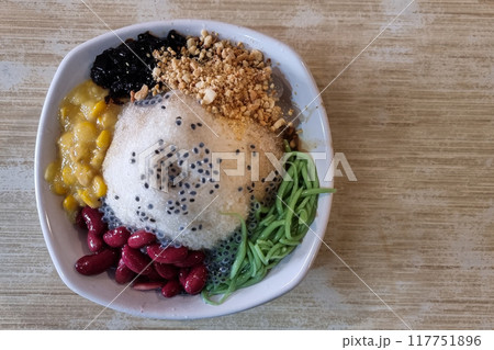 Overhead view of authentic ice kacang or shaved ice with ingredients like red beans, cendol and sweet corn is popular traditional delicacy in Malaysia Overhead view of authentic ice kacang or shaved ice with ingredients like red beans, cendol and sweet corn is popular traditional delicacy in Malaysia 117751896
