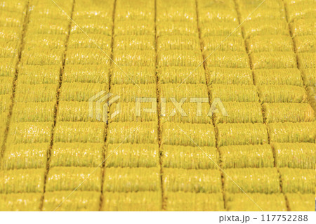 Rows of golden, crispy baklava neatly arranged in a pattern Rows of golden, crispy baklava neatly arranged in a pattern 117752288