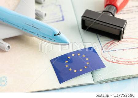 Eu flag with approved Stamp visa and passport document to immigration at airport in country. Eu flag with approved Stamp visa and passport document to immigration at airport in country. 117752580