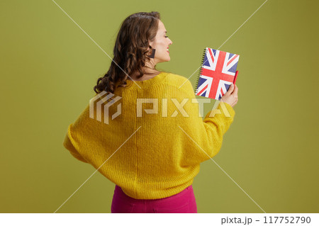 Seen from behind healthy woman against green background 117752790