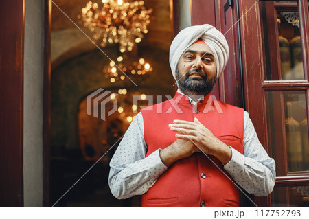 Indian man in a city. Male in a traditional turban. Hinduist in a summer city. 117752793