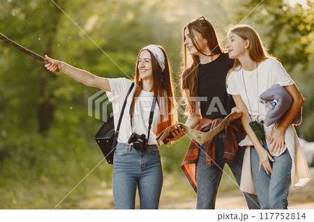 Adventure, travel, tourism, hike and people concept. Three girls in a forest. Adventure, travel, tourism, hike and people concept. Three girls in a forest. 117752814