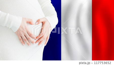 Demographics, pregnancy and love baby in France concept. Pregnant woman making heart  117753652