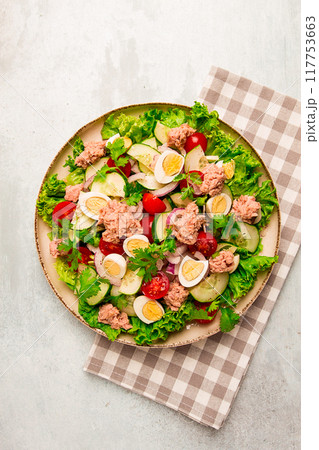 Tuna salad, vegetable salad with quail eggs, lettuce, red onion and cucumbers, on a light gray table, keto food, lifestyle, healthy eating, selective focus, top view, no people, 117753663