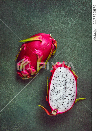 Dragon fruit, pitahaya, one piece, cut, top view, rustic style, green background, 117753676