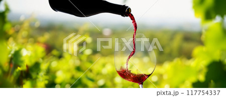 Wine glass with pouring red wine Wine glass with pouring red wine 117754337
