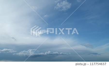 White cumulus and cirrus or cirrostratus cloudscape on beautiful sunny clear sky. Tropical summer sunlight. Timelapse. 117754637
