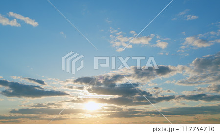 Warm colors of sky and clouds at sunset. Cloud nature background. Timelapse. 117754710