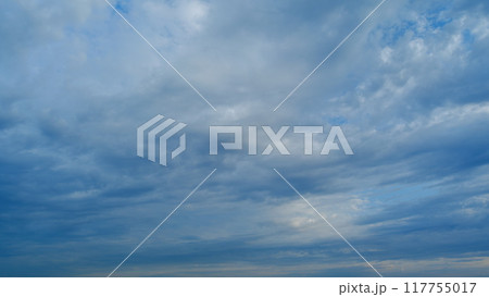 Background of clouds and sky on a sunny day. Light blue and white colours of real skies with clouds. Timelapse. 117755017