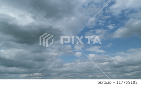 Dark storm clouds dramatic shadowy sky background. Dark grey storm clouds. Timelapse. 117755185