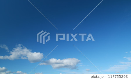 Blue sky with copyspace background with forming clouds in summer day outdoors. Timelapse. 117755298