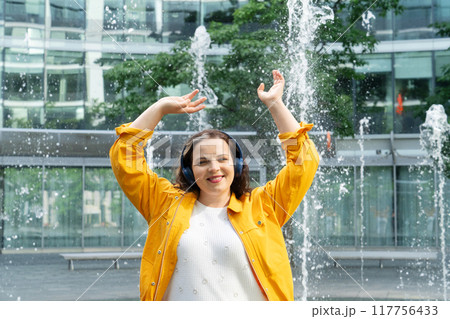 Happy curvy woman in city Happy curvy woman in city 117756433