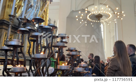Burning candles in a Catholic church during the Divine Service. Burning candles in a Catholic church during the Divine Service. 117756591