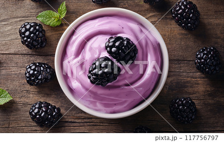 Greek yogurt with blackberries on wooden table with copy space, top view 117756797