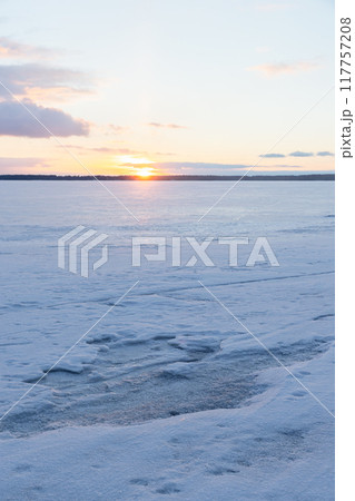 Winter landscape with frozen Baltic sea at sunset 117757208
