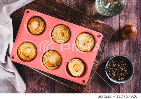 Caramelized baked onion halves in a baking dish on the table top view Caramelized baked onion halves in a baking dish on the table top view 117757926