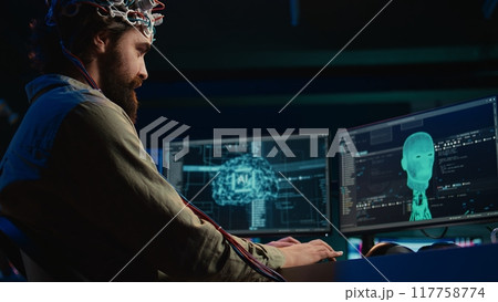 IT admin coding and using EEG headset to upload brain into computer, gaining immortality. Neuroscientist engineering transhumanism experiment, inserting consciousness into cyberspace, camera B 117758774