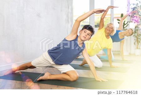 Family of three people practice yoga 117764618