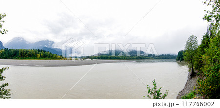 River with cloud covered green mountains in the background River with cloud covered green mountains in the background 117766002