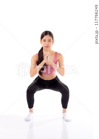 Full length portrait beautiful young asian woman in sportswear practicing doing squats. Full length portrait beautiful young asian woman in sportswear practicing doing squats. 117766249