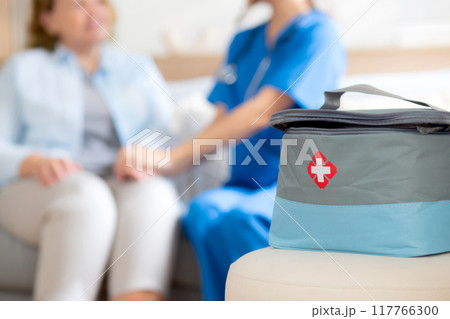 Caregiver young woman care elderly sitting on wheelchair and encourage in living room. 117766300