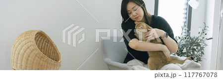pet care concept with owner during read book and take coffee break and play with cat in livingroom 117767078
