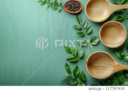 Green background with a variety of fruits and eco utensils, including a fork, spoon, and knife with copy space 117767430