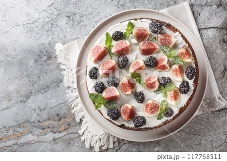 Dark mood cake with Figs, Blackberry and Ricotta Cake closeup on the plate. Horizontal top view 117768511