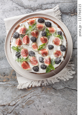 Italian fig and blackberry cake with cream cheese close-up in a plate. Vertical top view 117768515