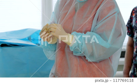 Medical staff surgeon wearing medical gloves preparate operation surgery. Team working professionalism of medical staff modern medicine hospital environments equipment quality medical care. Medical staff surgeon wearing medical gloves preparate operation surgery. Team working professionalism of medical staff modern medicine hospital environments equipment quality medical care. 117769118