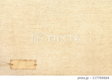Organic eco paper tag on Natural linen texture. Eco-friendly background with paper label on canvas. Sustainable development of strategy approach to zero waste, responsible consumption. Go green Organic eco paper tag on Natural linen texture. Eco-friendly background with paper label on canvas. Sustainable development of strategy approach to zero waste, responsible consumption. Go green 117769884