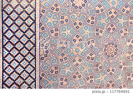 Vertical or horizontal background with detail of ancient mosaic walls with clay details and geometric ceramic tile ornament. Traditional iranian tile decorations 117769891