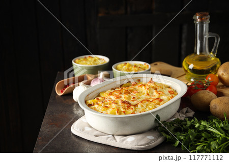 Concept of tasty and delicious homemade food - potato casserole Concept of tasty and delicious homemade food - potato casserole 117771112