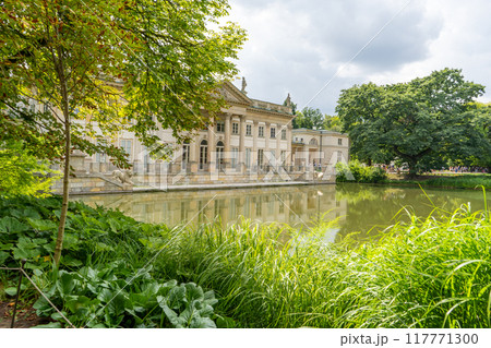Lazienki Park with pond. Polish Lazienkowski or Lazienki Krolewskie is the polish park. The palace on the water is a monument of architecture. Lazienki Park with pond. Polish Lazienkowski or Lazienki Krolewskie is the polish park. The palace on the water is a monument of architecture. 117771300