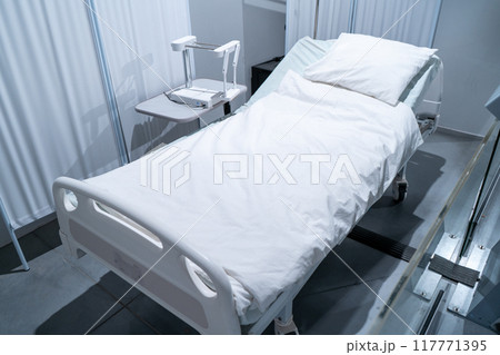 White bed in a hospital room. Blanket and pillow. 117771395