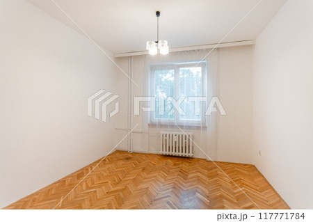 Empty room with herringbone parquet flooring and white walls Empty room with herringbone parquet flooring and white walls 117771784