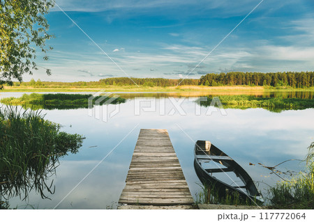 Old Wooden Fishing Boat Near Pier In Summer Lake Or River. Beautiful Summer Sunny Day Or Evening. Forsaken Boat. Russian Nature 117772064